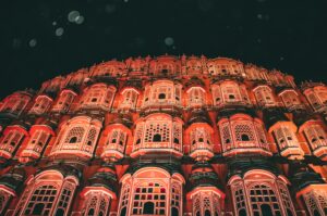 Stunning architectural shot of the illuminated Hawa Mahal at night in Jaipur.