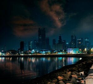 Stunning view of Mumbai's skyline at night, reflecting on water.